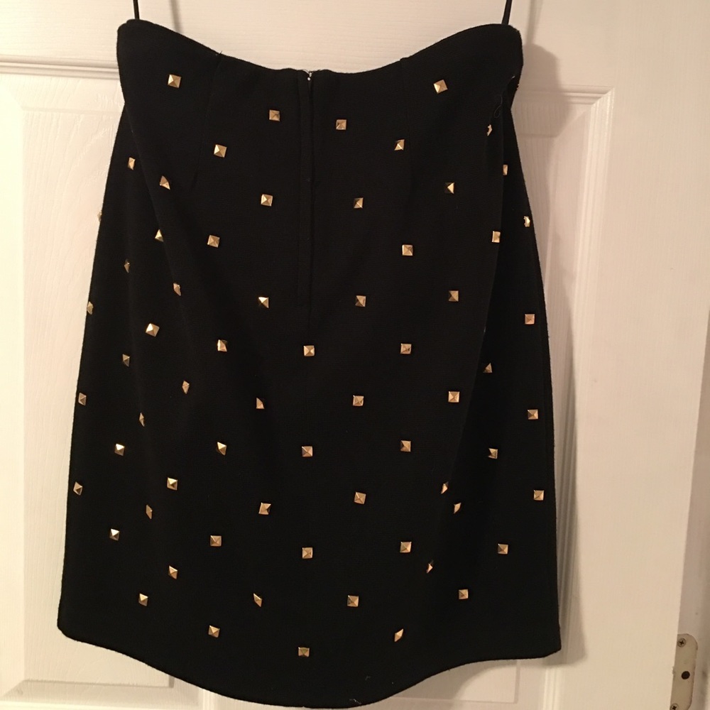 Black stretch knit skirt with all over gold rivets